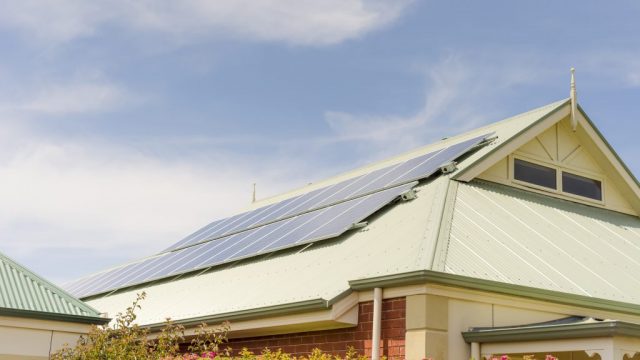 Solar panels on a suburban house rooftop