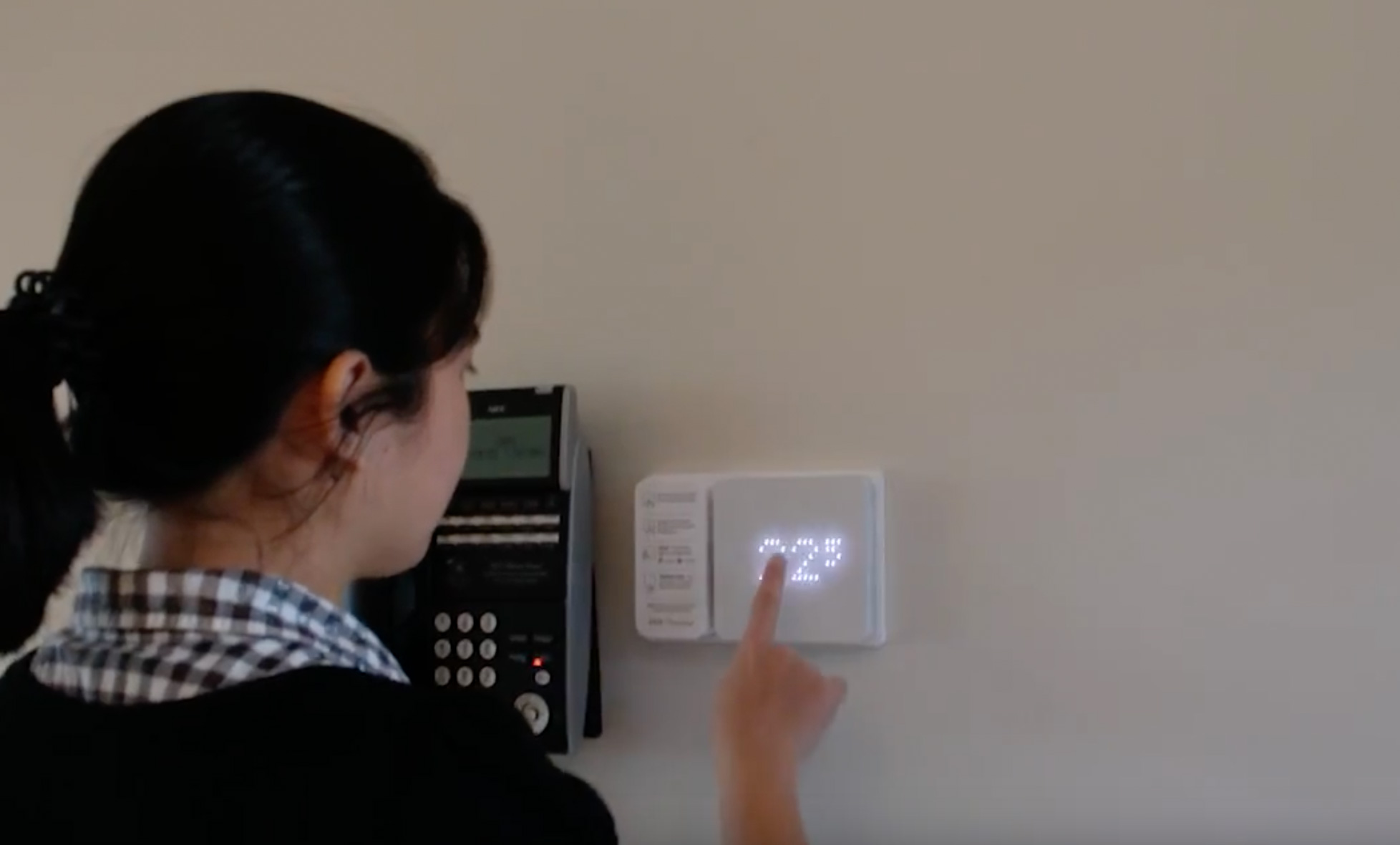 Teenage interacting with the Zen Thermostat