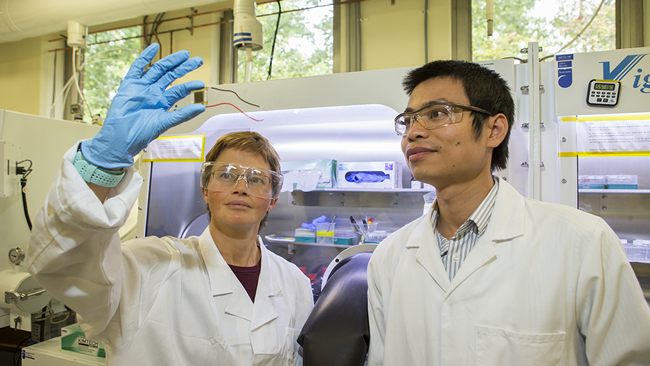 Researchers at ANU inspecting a solar cell