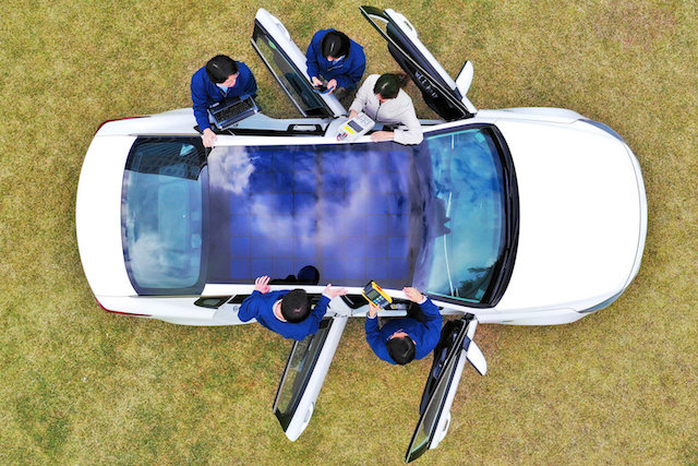 Electric vehicle with doors open arial view