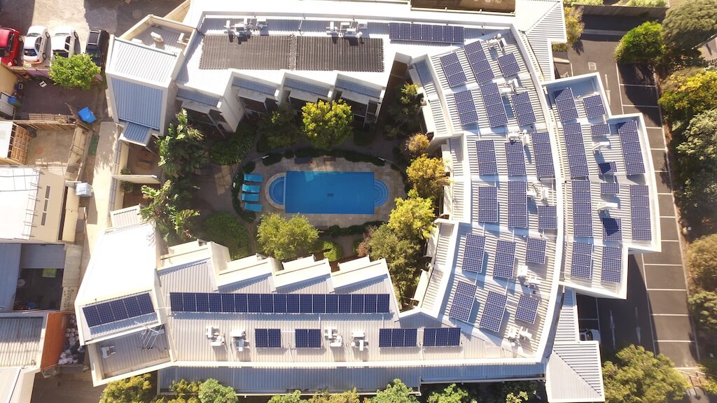 Arial view of apartment block with swimming pool