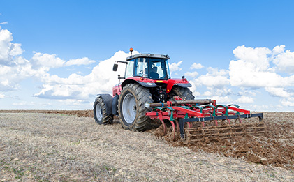 Image - Agribusiness tractor ploughing