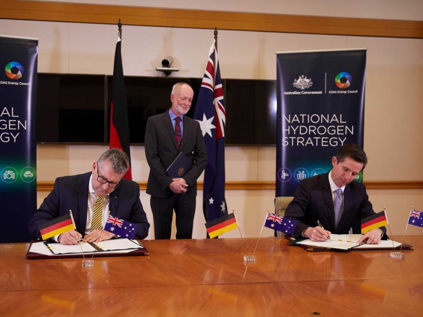 His Excellency Dr Thomas Fitschen, Ambassador of Germany, witnesses Australian ministers Birmingham and Pitt signing the declaration of intent