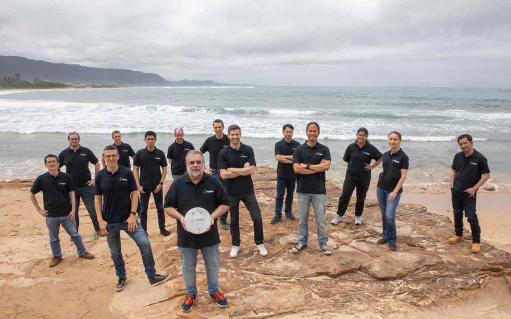 The team from hydrogen technology developer standing on a beach