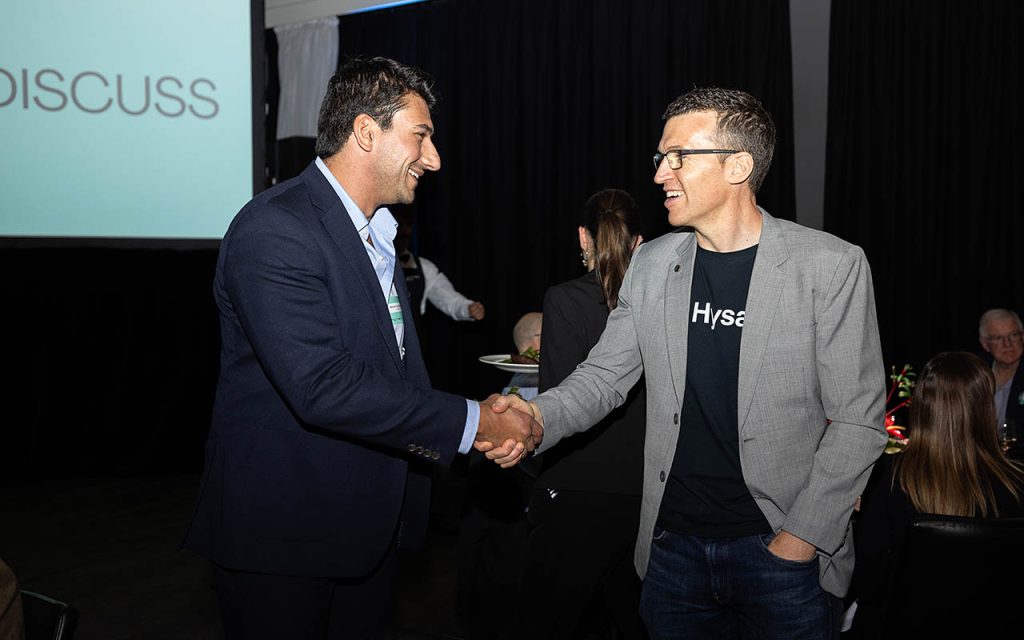 Novalith Technologies CEO and Founder Steven Vassiloudis shakes hands with Hysata CEO Paul Barrett